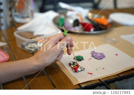 Mother and her daughter paint Halloween cookies  128217891