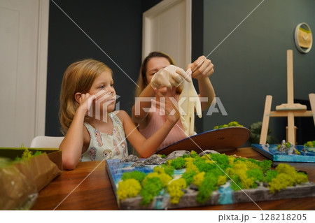 A mother and her daughter craft vibrant natural landscapes A mother and her daughter craft vibrant natural landscapes 128218205
