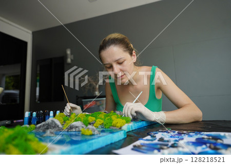 The process of making the art decor of epoxy resin, natural stones and moss The process of making the art decor of epoxy resin, natural stones and moss 128218521