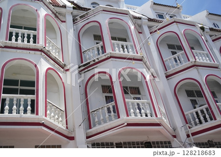 Detailed view of windows, doors and balconies of city buildings  128218683
