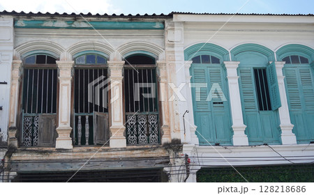 Detailed view of windows, doors and balconies of city buildings  128218686