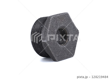 A close-up shot of a black, hex-shaped iron pipe fitting. 128219484
