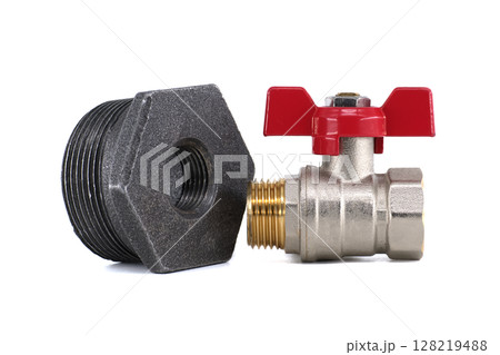 Detailed shot of plumbing components, including a valve and a threaded fitting, on a white backdrop. 128219488