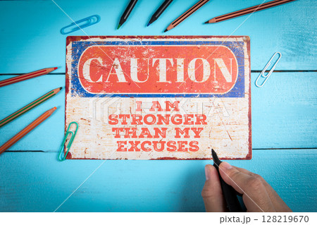 I AM STRONGER THAN MY EXCUSES. Motivational Quote Sign on Blue Background 128219670