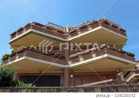 Modern apartment building with spacious balconies. Urban architecture concept Modern apartment building with spacious balconies. Urban architecture concept 128220232