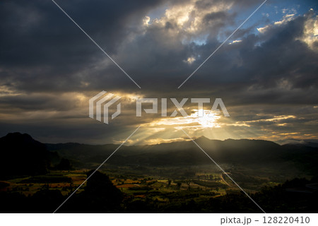 Scenic view dramatic beautiful sunset sky. Natural Sunset Sunrise on meadow silhouette shadow dark land. Vibrant dramatic sky on sunset, dawn, sunrise in Countryside. Landscape Colorful Sky At Sunset 128220410