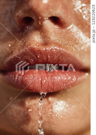 Close up of wet lips and woman face with drops of water on skin 128220628
