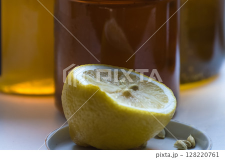 Still life with lemon and spices on a white background. Selective focus. Still life with lemon and spices on a white background. Selective focus. 128220761