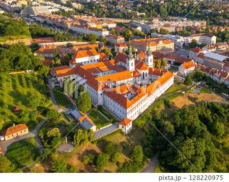 A breathtaking aerial view captures Strahov Monastery in Prague during sunrise. A breathtaking aerial view captures Strahov Monastery in Prague during sunrise. 128220975