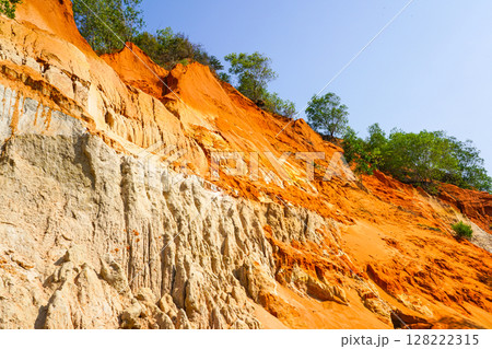 Stunning Red and White Sandstone Cliffs of Ham Tien Canyon Under a Bright Blue Vietnamese Sky Stunning Red and White Sandstone Cliffs of Ham Tien Canyon Under a Bright Blue Vietnamese Sky 128222315