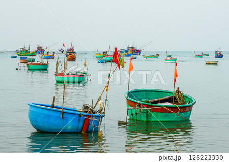 Colorful Basket Boats Floating Calmly in Mui Ne Bay, a Traditional Vietnamese Fishing Scene 128222330