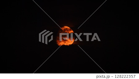 Full orange moon Moonrise in Dark Night cloudy Sky natural Background. nighttime Yellow Moon 128222357