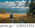 Off-road vehicle enjoying stunning lake and mountain view in autumn 128223502