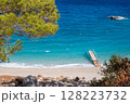 Wooden pier stretching into vibrant turquoise mediterranean sea, greece 128223732