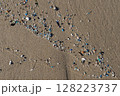 Microplastics polluting sand on the beach, environmental disaster 128223737