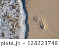 Footprint on the sand washed by the sea waves 128223748
