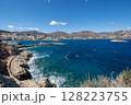 Waves crashing on the rocky coast of Karpathos on a sunny day, Greece 128223755