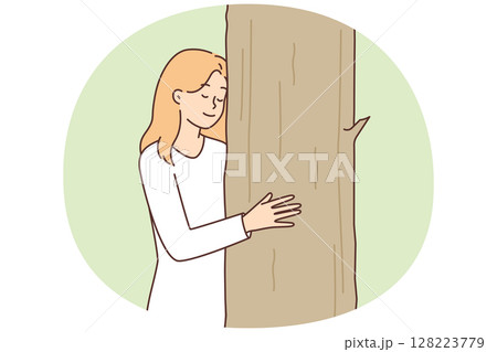 Teenage girl caringly hugging tree cuddling up to plant for concept of caring for nature 128223779