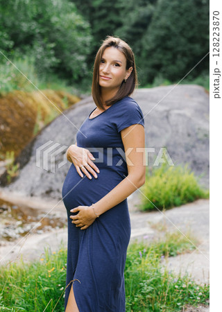 Elegant Pregnant Woman Standing Outdoors In Nature Elegant Pregnant Woman Standing Outdoors In Nature 128223870