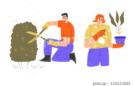 Professional gardeners are diligently engaged in the artistry of planting and pruning plants 128223885