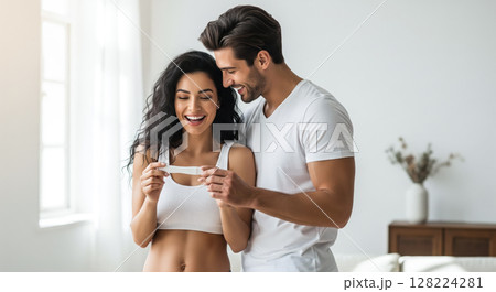 A couple looking at a pregnancy test together, sharing a joyful and emotional moment. The concept of partnership, new life, and the beginning of parenthood. Generative AI. 128224281