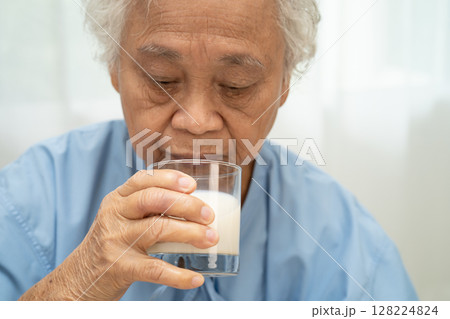 Asian elderly woman patient drinking milk food in breakfast. Asian elderly woman patient drinking milk food in breakfast. 128224824