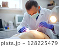 Surgeon performing a skin surgery with surgical instruments 128225479