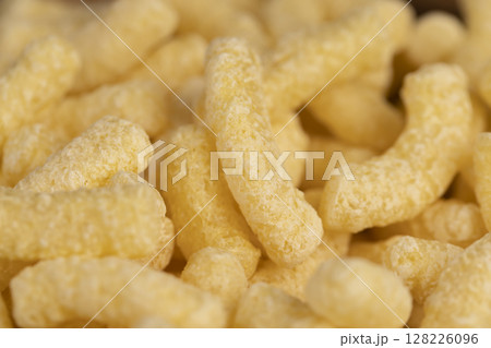 corn sticks from flour, a large number of corn sticks for eating or making breakfast with milk, corn sticks in a wooden bowl, close up corn sticks from flour, a large number of corn sticks for eating or making breakfast with milk, corn sticks in a wooden bowl, close up 128226096