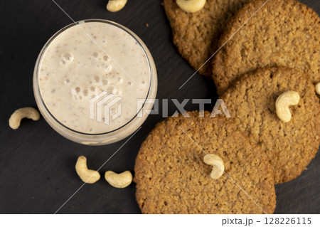crunchy cookies and a glass of yogurt with prunes, a light breakfast of oatmeal cookies and a glass of yogurt, closeup 128226115