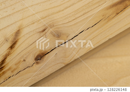 old wooden board with cracks, a pine wood board cracked during operation, closeup 128226148