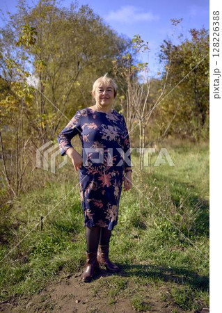 a portrait of an elderly woman with gray hair in a dress in the autumn forest a portrait of an elderly woman with gray hair in a dress in the autumn forest 128226388