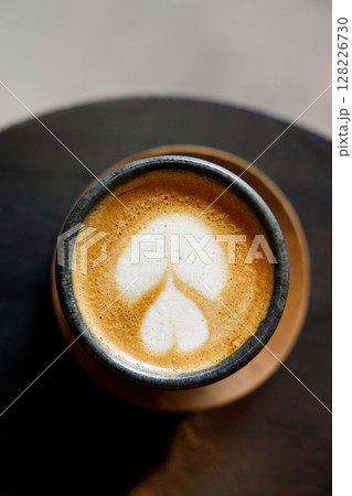 Cup of milk latte coffee on table by the street. 128226730