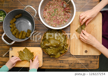 Dolma preparation with grape leaves and meat filling at a home kitchen 128227254