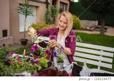 Gardener with vibrant flowers in a sunny space Gardener with vibrant flowers in a sunny space 128228477