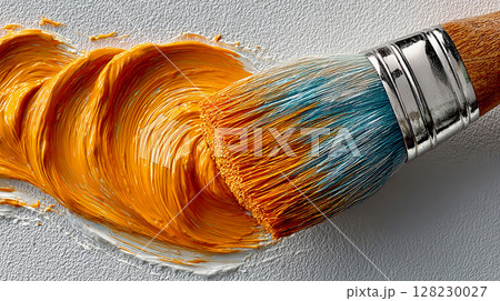 Bright orange paint swirls created with a brush on a textured surface during an art project in a creative studio setting 128230027