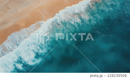 Aerial view of ocean waves meeting a sandy beach shoreline with vivid colors. Aerial view of ocean waves meeting a sandy beach shoreline with vivid colors. 128230508