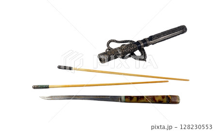This antique Mongolian food set includes a decorative knife and traditional chopsticks, showcasing exquisite craftsmanship and cultural significance, displayed on a white background. 128230553
