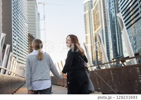 Happy walk, family together. Daughter and mother having fun outdoors Happy walk, family together. Daughter and mother having fun outdoors 128231693