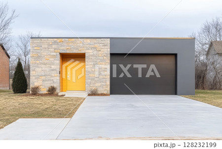 Modern home design featuring a striking yellow door and sleek stone facade 128232199