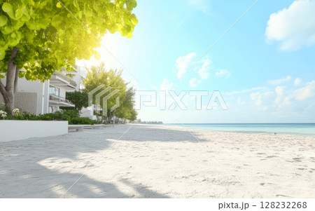 Serene beach front with soft sand and gentle waves under a clear blue sky 128232268