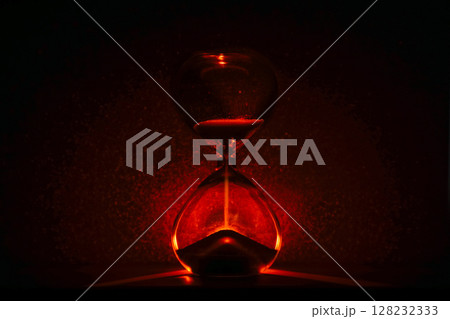 artistic glowing hourglass like sunrise or sunset, symbolizing time and creativity. Vibrant lighting against a dark minimalist backdrop. Concepts of time management, life balance, and artistic design. artistic glowing hourglass like sunrise or sunset, symbolizing time and creativity. Vibrant lighting against a dark minimalist backdrop. Concepts of time management, life balance, and artistic design. 128232333