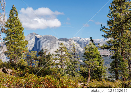Mountain landscape in Yosemite National Park with towering granite cliffs, green forests 128232655