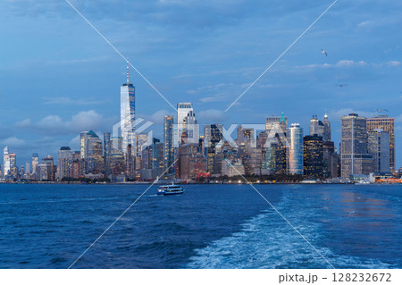 A vibrant sunset panorama of Manhattan downtown skyline, viewed from the river 128232672