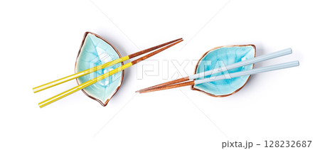A sushi chopsticks and a small bowls, elegantly arranged on a clean white background A sushi chopsticks and a small bowls, elegantly arranged on a clean white background 128232687
