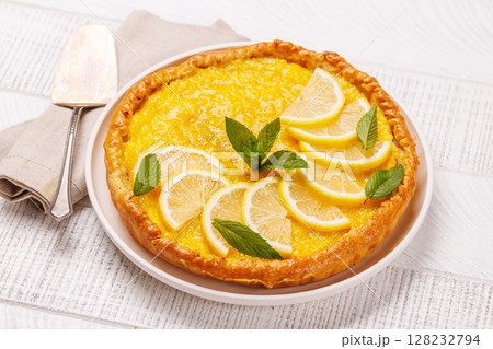 Delicious lemon tart with golden crust and smooth, glossy lemon filling Delicious lemon tart with golden crust and smooth, glossy lemon filling 128232794
