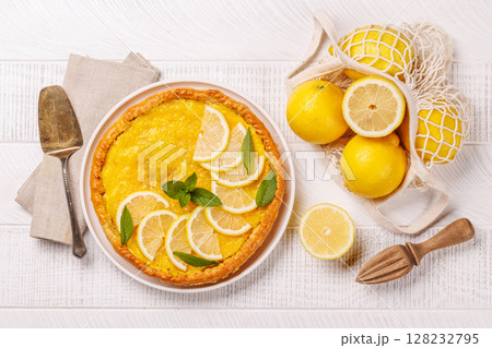 Delicious lemon tart with golden crust and smooth, glossy lemon filling 128232795