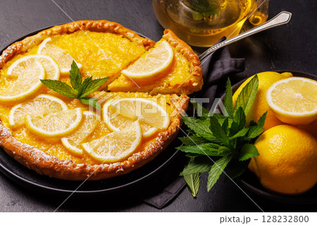 Delicious lemon tart with golden crust and smooth, glossy lemon filling Delicious lemon tart with golden crust and smooth, glossy lemon filling 128232800