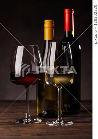 Wine glasses filled with wine beside a bottles Wine glasses filled with wine beside a bottles 128232820
