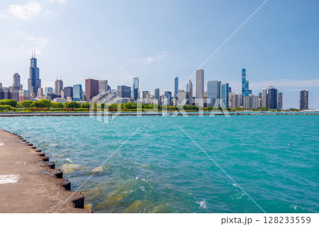 Bright and sunny view of downtown Chicago with the shimmering Michigan lake in the foreground Bright and sunny view of downtown Chicago with the shimmering Michigan lake in the foreground 128233559