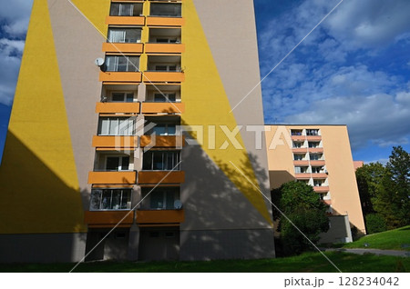 Original prefabricated houses on a housing estate from the communist era in Eastern and Central Europe after reconstruction.. Facade of a modern apartment building with windows and balconies. Czech 128234042